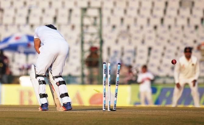 England's Chris Woakes is bowled by Umesh Yadav