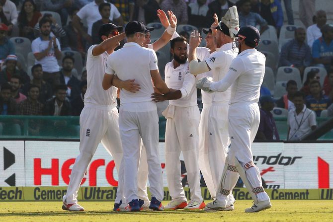 England's Adil Rashid celebrates the wicket of Cheteshwar Pujara on day 2 of the third Test in Mohali