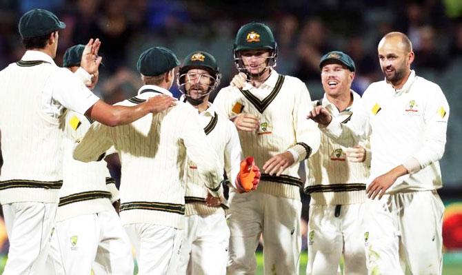 Australian team mates congratulate captain Steve Smith on his catch dismissing South Africa's Temba Bavama