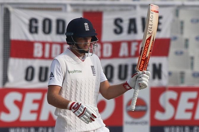 Joe Root celebrates his half century