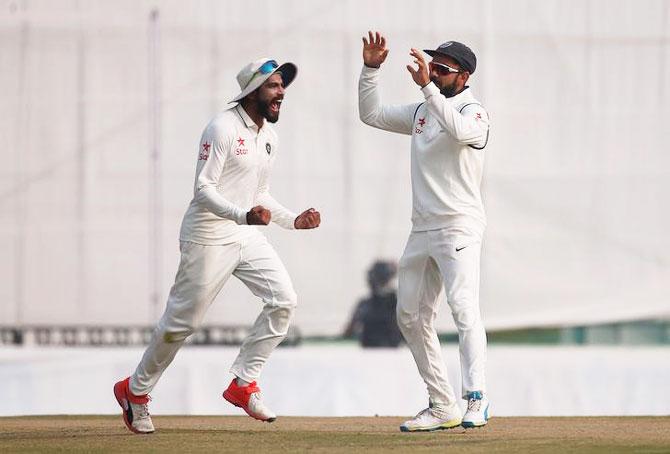 India's Virat Kohli and Ravindra Jadeja (left) celebrate the dismissal of England's Jos Buttler