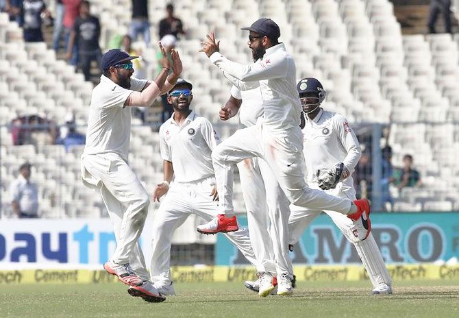 India's captain Virat Kohli (2nd from right) celebrates with his teammates after the dismissal of New Zealand's Ross Taylor on Day 4 of the 2nd Test at the Eden Gardens in Kolkata on Monday
