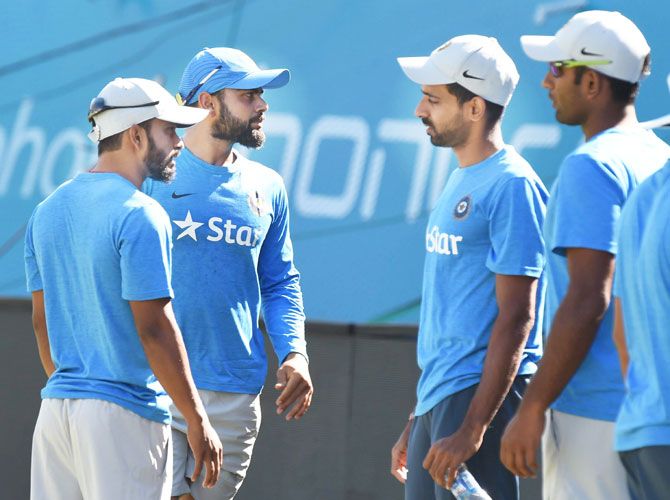 India's Virat Kohli and Dhawal Kulkarni with teammates at a practice session on Saturday