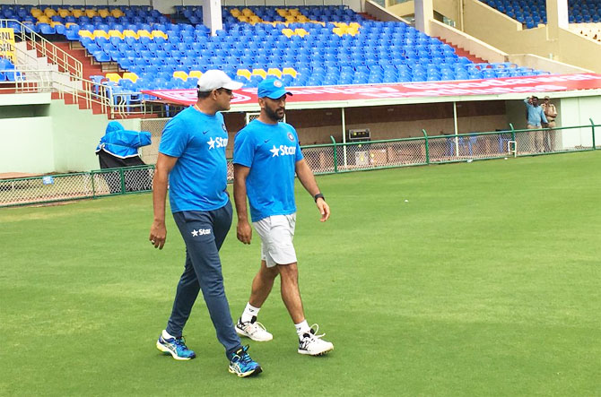 India's head coach Anil Kumble and captain MS Dhoni walk into the ACA-VDCA Stadium in Vishakapatnam for an optional nets session on Friday