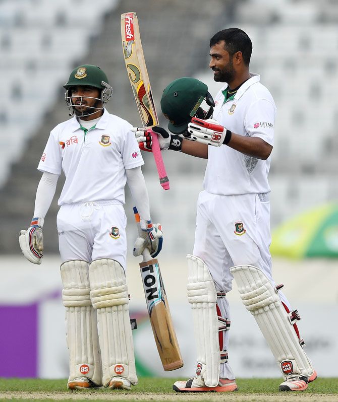 Bangladesh's Tamim Iqbal celebrates with Mominul Haque after reaching his century on Friday