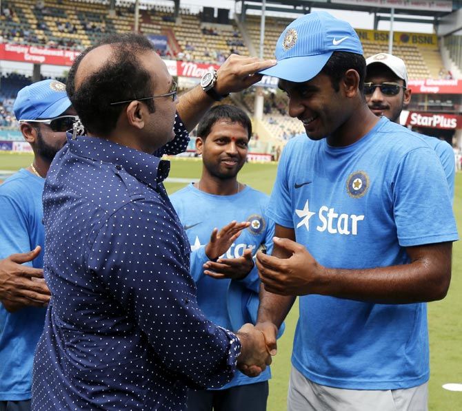 Jayant Yadav, who has acknowledged Rahul Dravid's influence on him, gets his debut ODI India cap from batting legend Virender Sehwag ahead of the game against New Zealand at Vizag, October 29, 2016.
