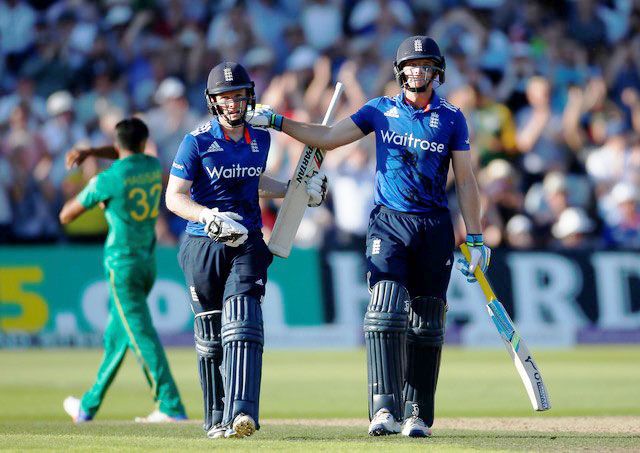 England's Jos Buttler and Eoin Morgan celebrate at the end of the innings after breaking the world record for the highest ODI score against Pakistan on Tuesday