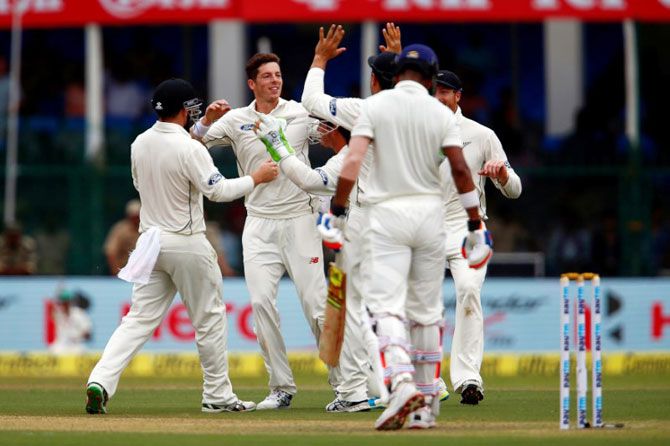 New Zealand's Mitchell Santner celebrates with teammates after scapling the wicket of India's Lokesh Rahul