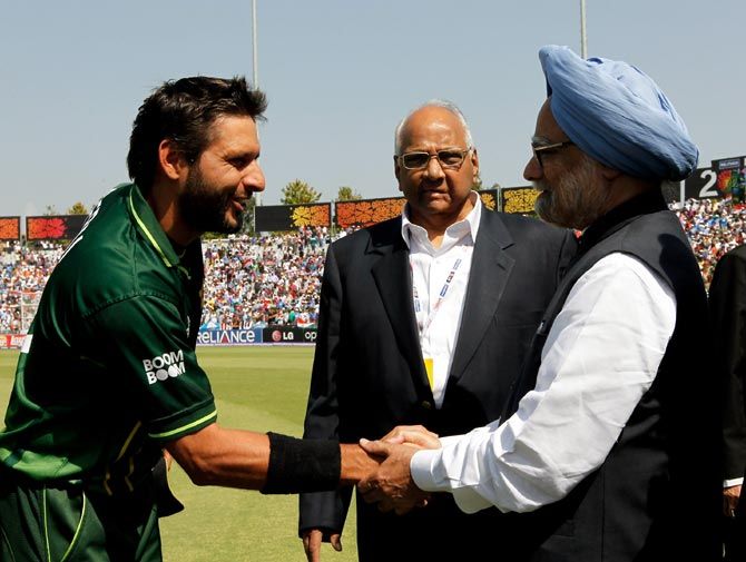 A file photograph of Pakistani cricketer Shahid Afridi, left, shaking hands with India's then prime minister Manmohan Singh, as then ICC president Sharad Pawar looks, during the 2011 World Cup semi-final between India and Pakistan in Mohali, on March 30, 2011