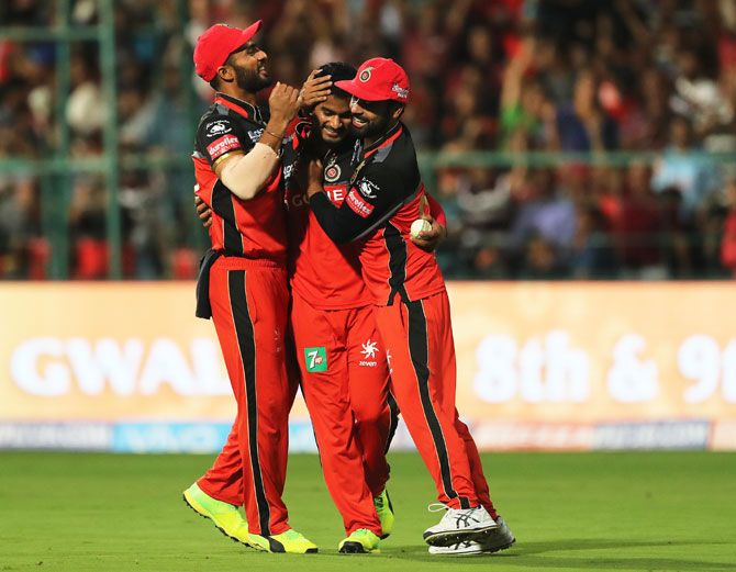 Royal Challengers Bangalore's Pawan Negi celebrates with teammates after picking the wicket of Delhi Daredevils' Shahbaz Nadeem in the final over during their Indian Premier League match in Bengaluru on Saturday