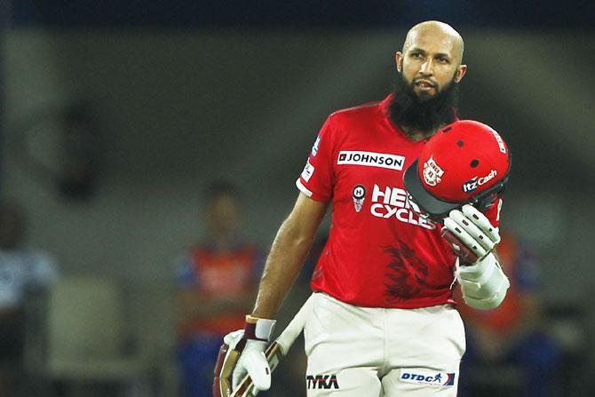 Kings XI Punjab's Hashim Amla celebrates on scoring his century against Mumbai Indians, his first IPL and T20 ton, in Indore on Thursday