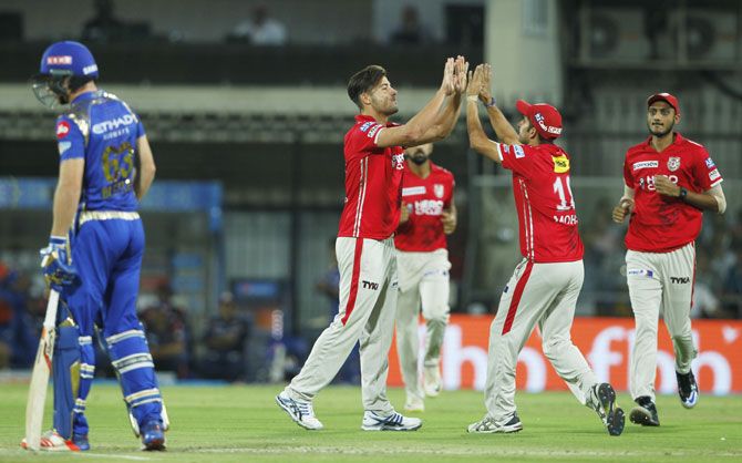 Punjab's Marcus Stoinis celebrates the wicket of Parthiv Patel
