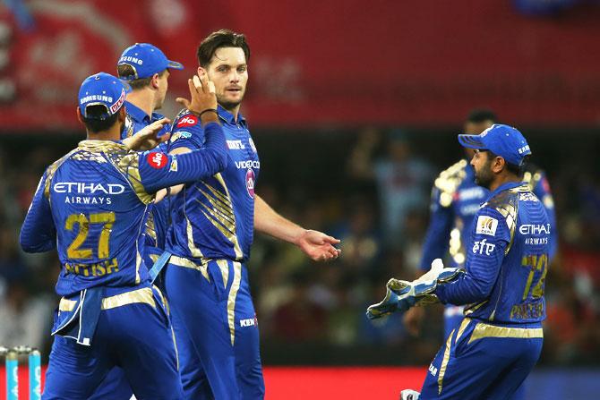 Mumbai Indians players congratulate Mitchell McClenaghan after dismissing King's XI Punjab's Shaun Marsh