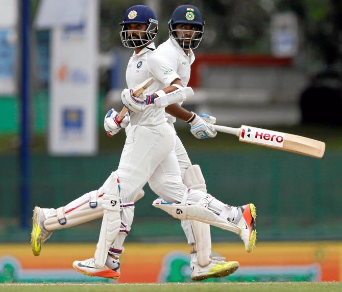 Ajinkya Rahane, left, and Ravichandran Ashwin run between the wickets