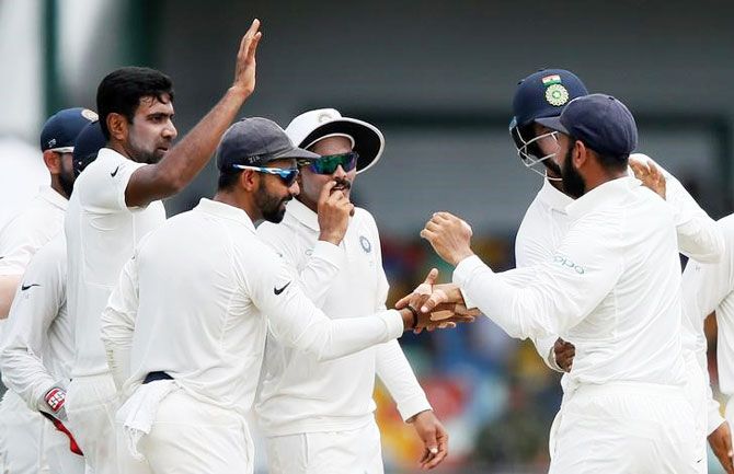 India's Ravichandran Ashwin celebrates with his teammates after taking the wicket of Sri Lanka's Angelo Mathews
