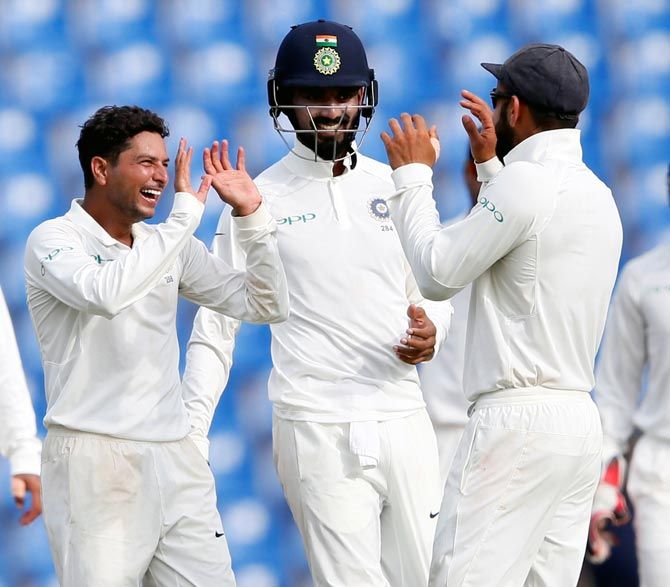 Kuldeep Yadav celebrates with KL Rahul and captain Virat Kohli after bowling out Vishwa Fernando on Day 2 of the 3rd Test in Pellekele on Sunday