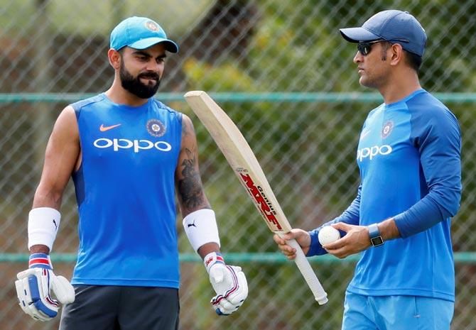 Virat Kohli, left, with Mahendra Singh Dhoni during a training session