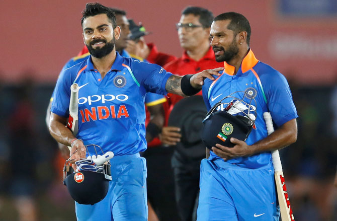 India's captain Virat Kohli and opener Shikhar Dhawan walk off the field in celebration after victory in the 1st ODI against Sri Lanka on Sunday