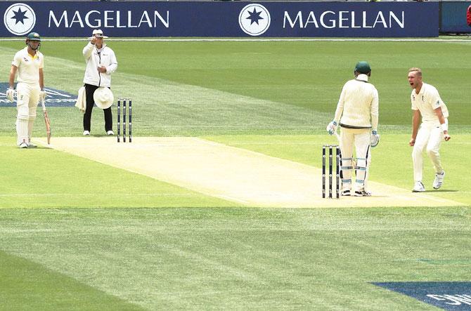 England's Stuart Broad celebrates after taking the wicket of Australia's Peter Handscomb on Day 2 of the second Ashes Test series at Adelaide Oval in Adelaide, Australia, on Sunday