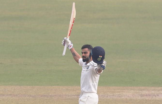 Virat Kohli celebrates after completing his double century