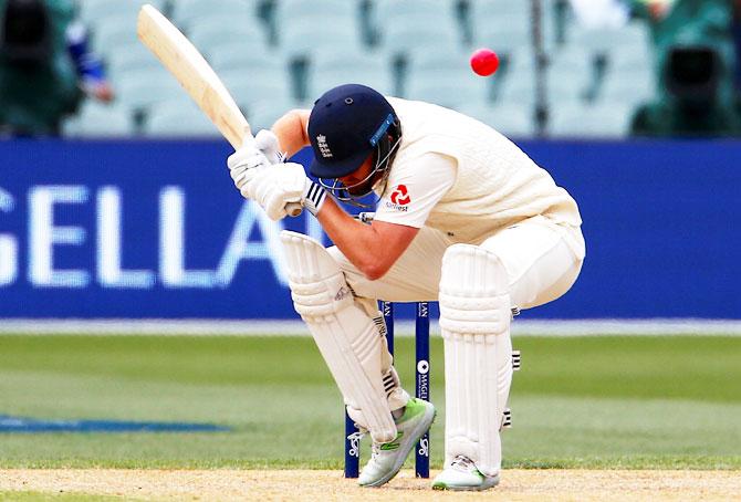 England's Jonny Bairstow avoids a short delivery from Australia's Pat Cummins