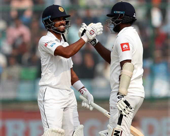 Dinesh Chandimal congratulates Angelo Mathews on completing his century on Day 3 of the 3rd Test at the Feroz Shah Kotla in New Delhi on Monday