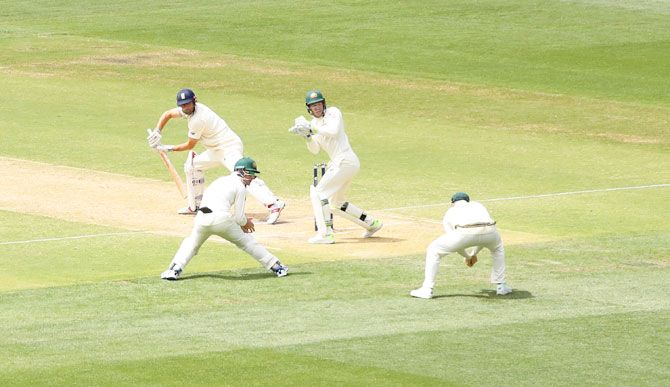 Australia's Steve Smith (right) takes a catch to dismiss England's Alastair Cook off the bowling of Nathan Lyon