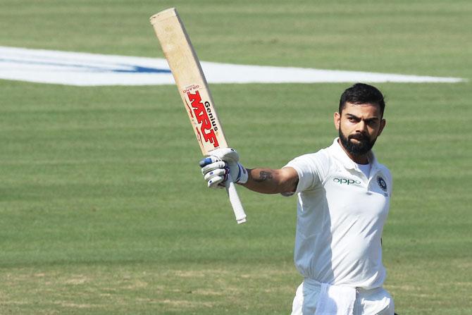 Virat Kohli celebrates after completing his double century 