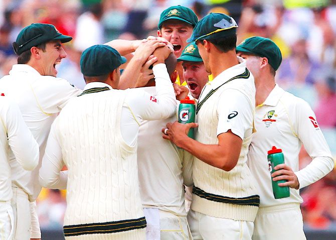 Austrlia players celebrate after England's Alastair Cook is dismissed by Nathan Lyon on Day 4 of the 2nd Test at the Adelaide Oval on Tuesday