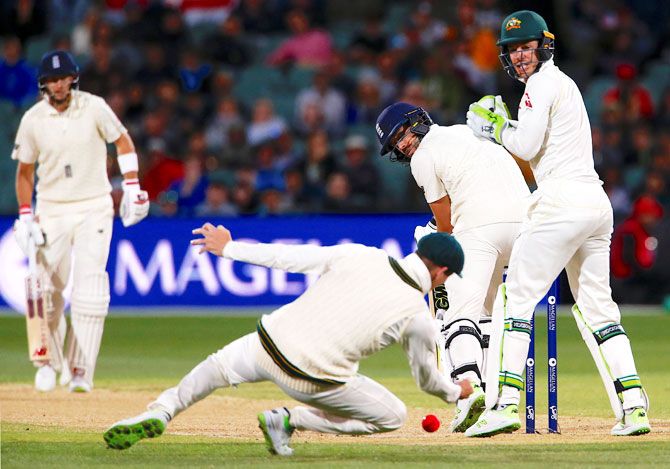 England's captain Joe Root watches as Australia's captain Steve Smith drops to hand England's Dawid Malan a reprieve