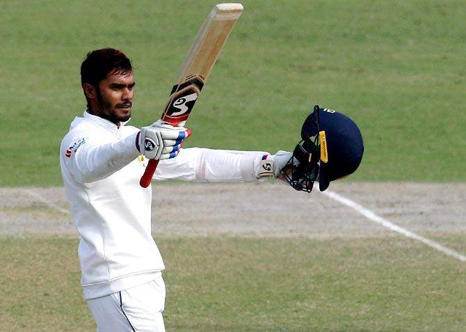 Sri Lanka's Dhananjaya de Silva celebratesd on completing a century in the 3rd Test against India at the Feroz Shah Kotla Stadium in New Dehli on Wednesday