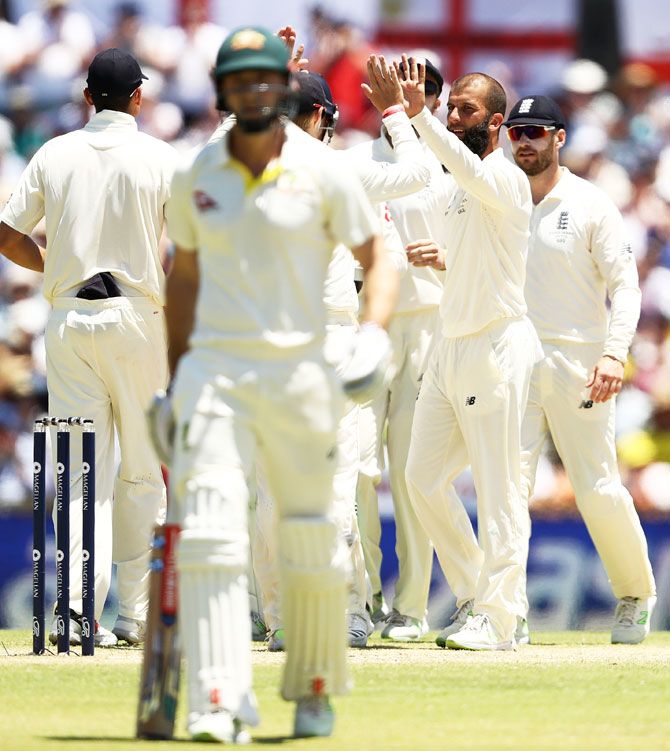 England's Moeen Ali celebrates after taking the wicket of Australia's Shaun Marsh