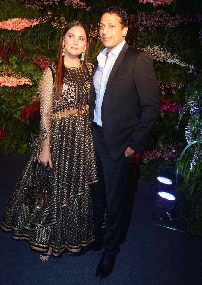 Actor and model Lara Dutta and her husband, India's Davis Cup captain Mahesh Bhupathi, walk in arm-in-arm and dressed in their finest