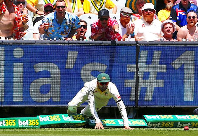 Australia's Nathan Lyon fields to stop a boundary