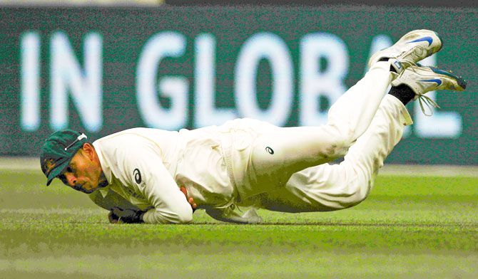 Australia's Usman Khawaja dives to take a catch to dismiss England's Stuart Broad
