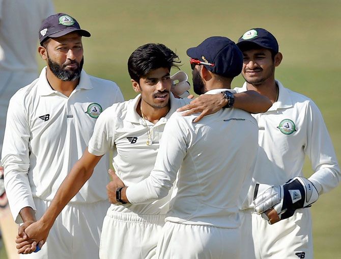 Vidarbha bowler Rajnish Gurbani celebrates his 6th wicket with his teammates on the 2nd day of the Ranji Trophy final against Delhi in Indore on Saturday