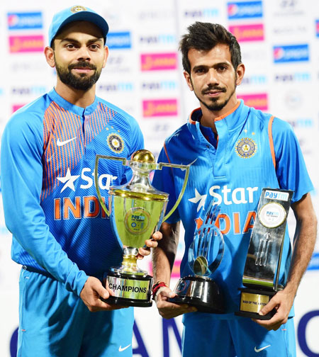 India captain Virat Kohli with the trophy after the series win and Yuzvendra Chahal with his man-of-the-match trophy