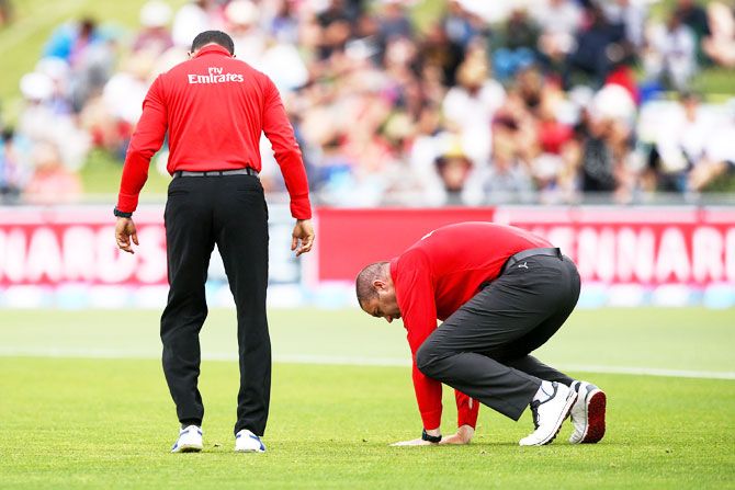 Umpires Kumar Dharmasena and Chris Brown check the playing surface at McLean Park in Napier, New Zeland on Thursday