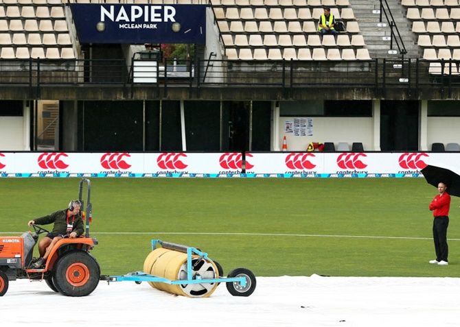  Ground staff tend to the covers prior to the second One-day International between New Zealand and Australia at McLean Park in Napier, New Zealand