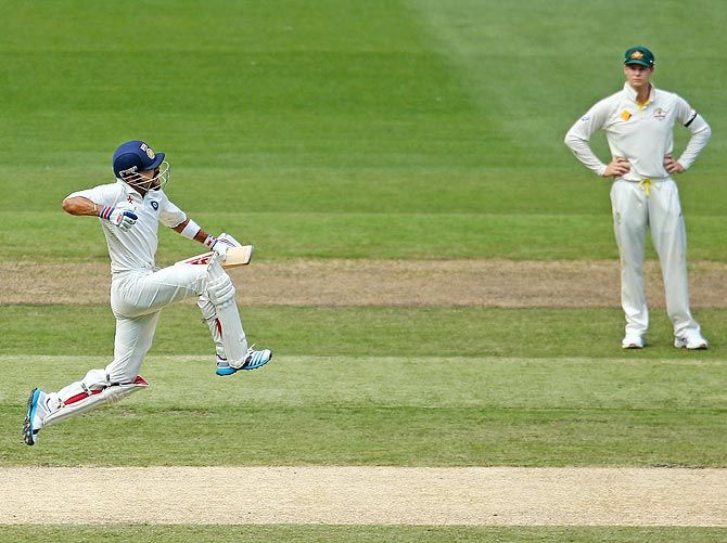  Virat Kohli celebrates his century as Steve Smith looks on during the Melbourne Test in 2014. Photograph: Photograph: Scott Barbour/Getty Images