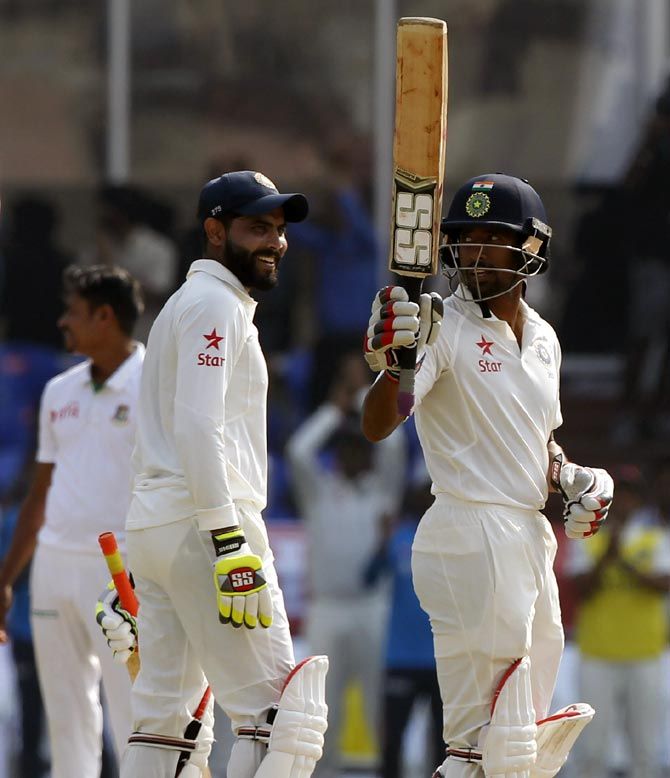 India's wicket-keeper batsman Wriddhiman Saha celebrates his century against Bangladesh at Hyderabad on Friday