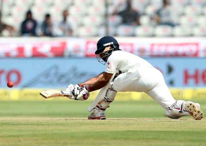 Wriddhaman Saha plays a sweep shot en route his century