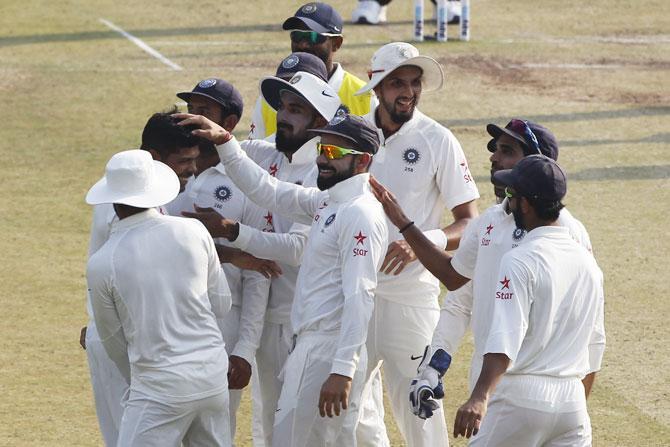 India players congratulate Umesh Yadav after the dismissal of Soumya Sarkar 