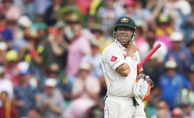 Australia's David Warner walks back to the pavillion after being dismissed by Pakistan's Wahab Riaz