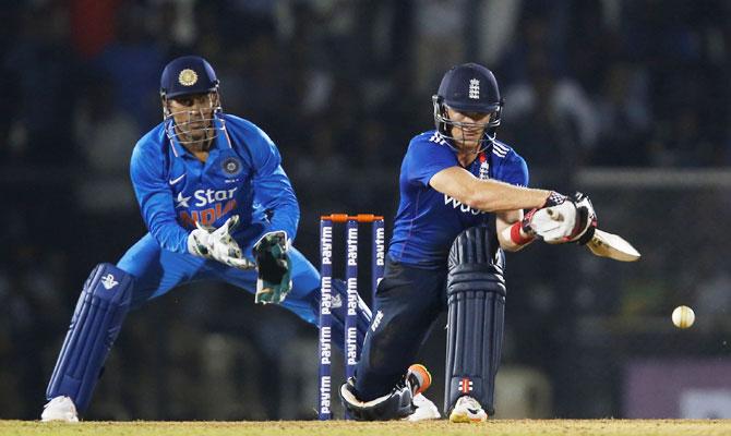 England XI's Sam Billings bats as India 'A' captain and wicket-keeper watches during the first warm-up match at the Brabourne Stadium in Mumbai on Tuesday