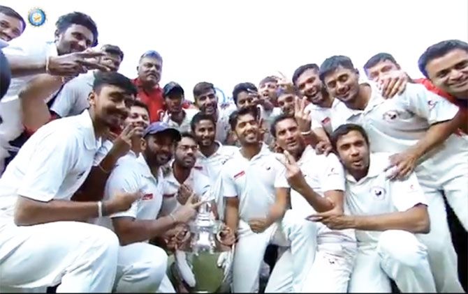The Gujarat team celebrate with the Ranji Trophy in Indore on Saturday