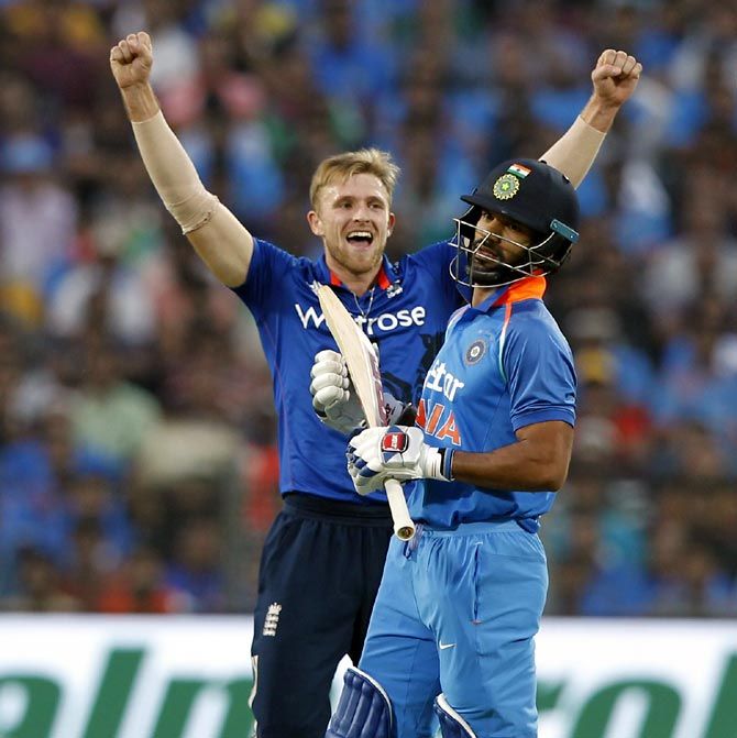 David Willey celebrates the wicket of Shikhar Dhawan during the first ODI in Pune