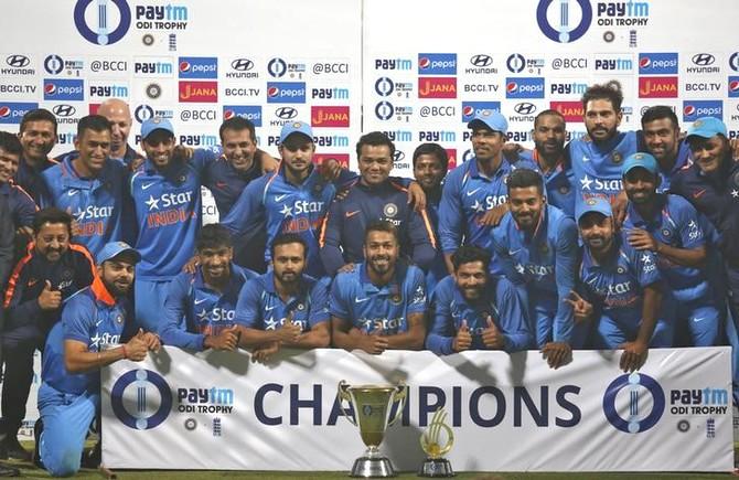 The Indian cricket team poses with the trophy on Sunday after claiming the 3-match series 2-1