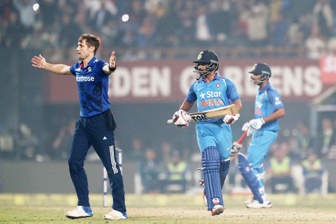 England's Chris Woakes celebrates the wicket of India's Kedar Jadhav during the third One Day International at Eden Gardens in Kolkata on Sunday