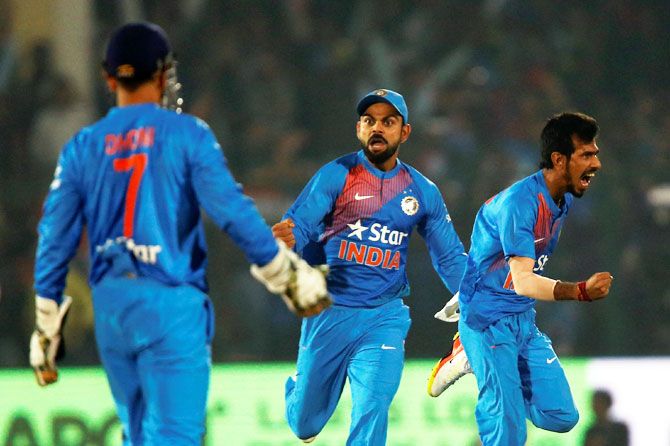 India's captain Virat Kohli and Yuzvendra Chahal celebrate the wicket of England's Sam Billings